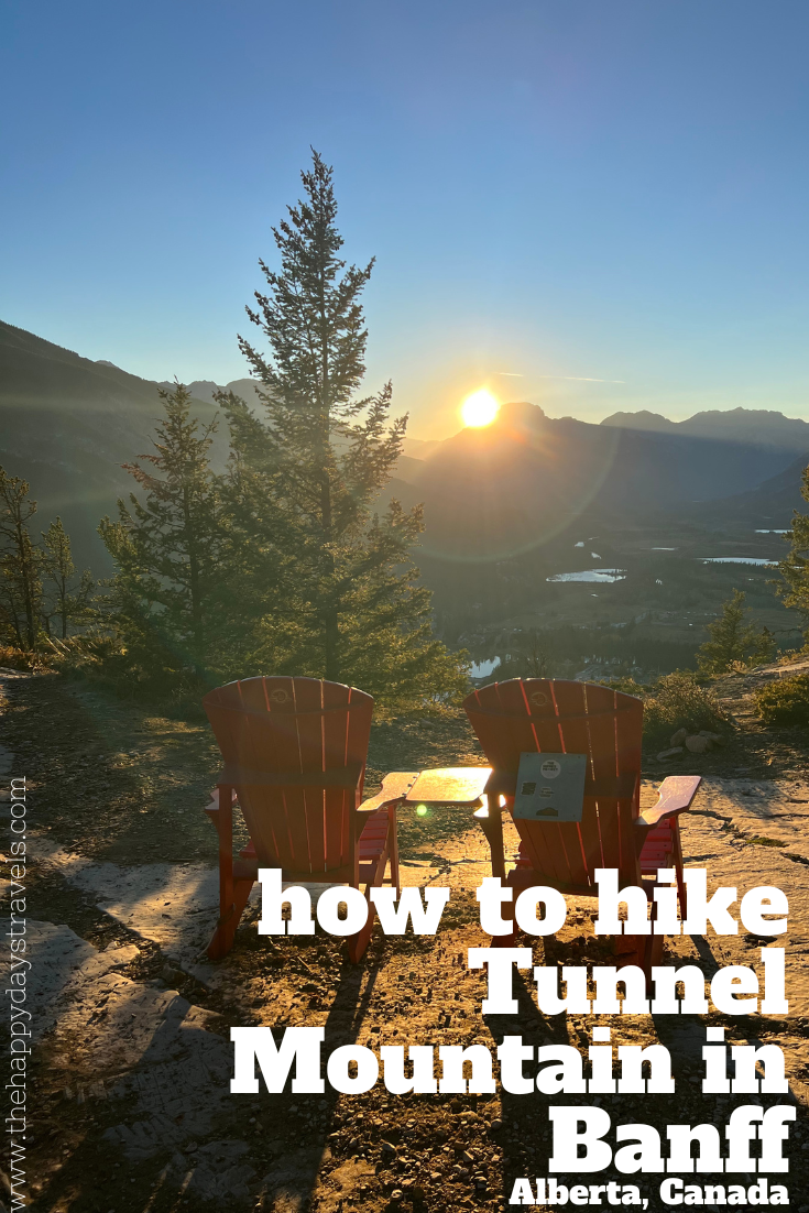 pin image of two red deck chairs with Banff town and Rocky mountains in the background as the sun is setting. Text reads 'how to hike Tunnel Mountain in Banff, Alberta, Canada'