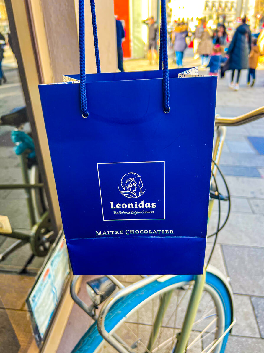 A blue bag from Leonidas held up in Brussels Belgium