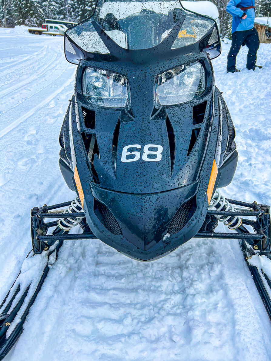 Image of front of black 'Ski-doo' snowmobile on snow