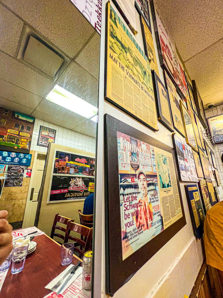 Image of Schwartz wall and mirror inside the deli