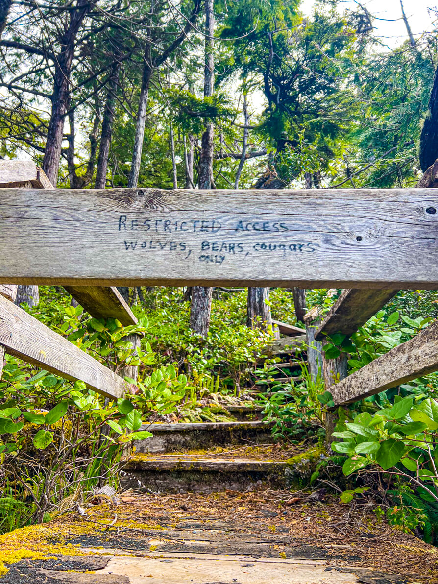 Image of sign in Ucluelet reading 'restricted access. Wolves, Bears, Cougars only'