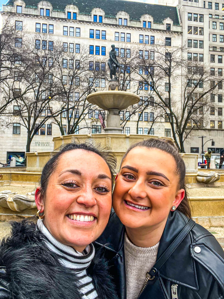 Shireen and her sister posing outside Pulitzer Fountain in New York City like Gossip Girl Filming Location