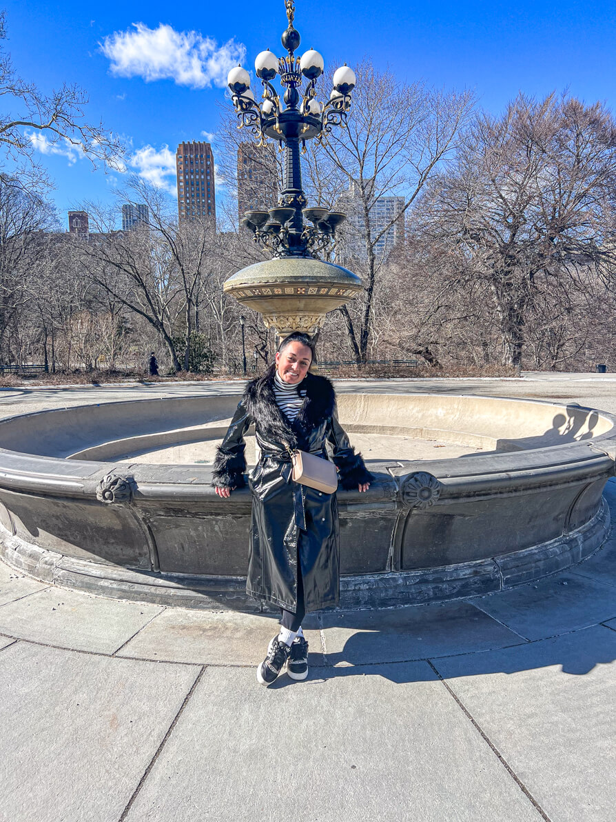 Image of Shireen leaning on the Cherry Hill Fountain aka the Friends Fountain in New York
